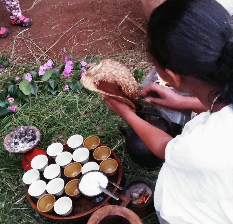 Pouring coffee into the jebena